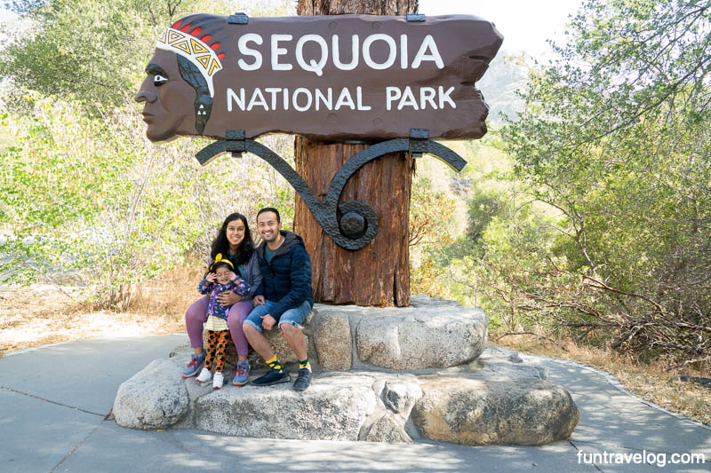 A photo of Supriya, Bharat and Raahi at Sequoia National Park entrance