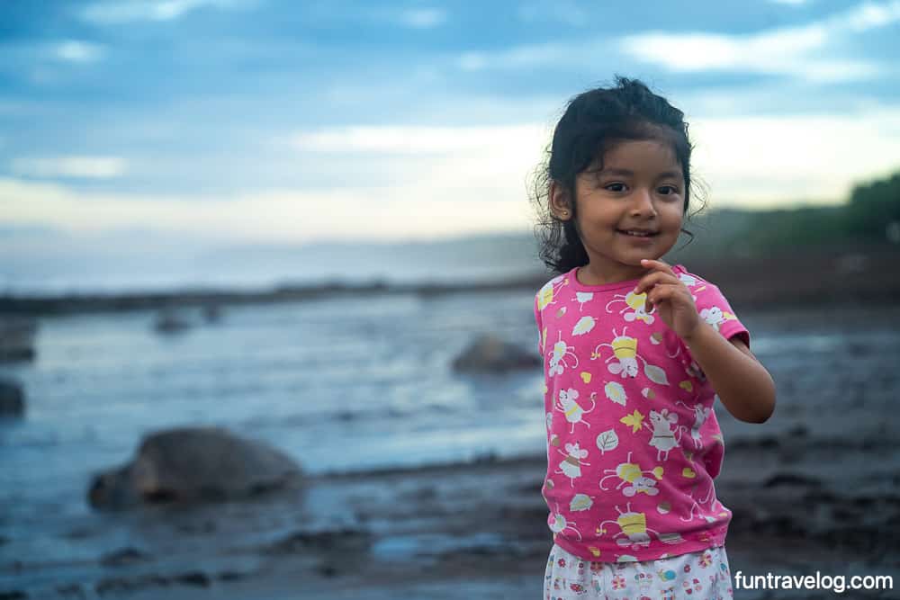 Raahi standing near turtles on the beach in Costa Rica