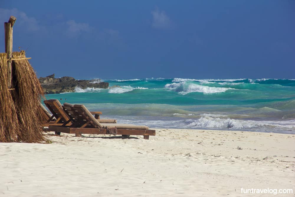 Beach loungers by the sea in Tulum
